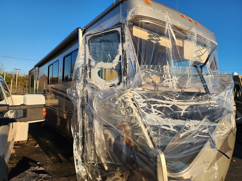 A damaged motorhome photographed in Woodburn by Ken. Plan storage and inspection access early.